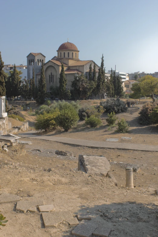 the view from the ground of a church across a barren field