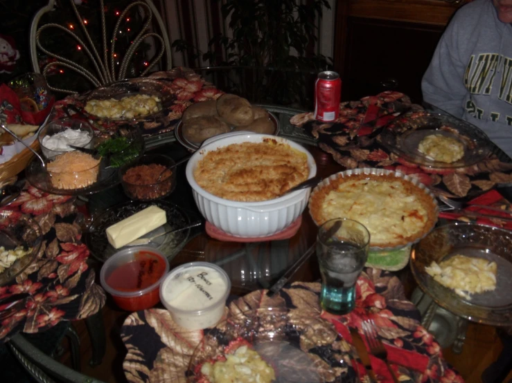 the table is covered in many pies, breads and cakes