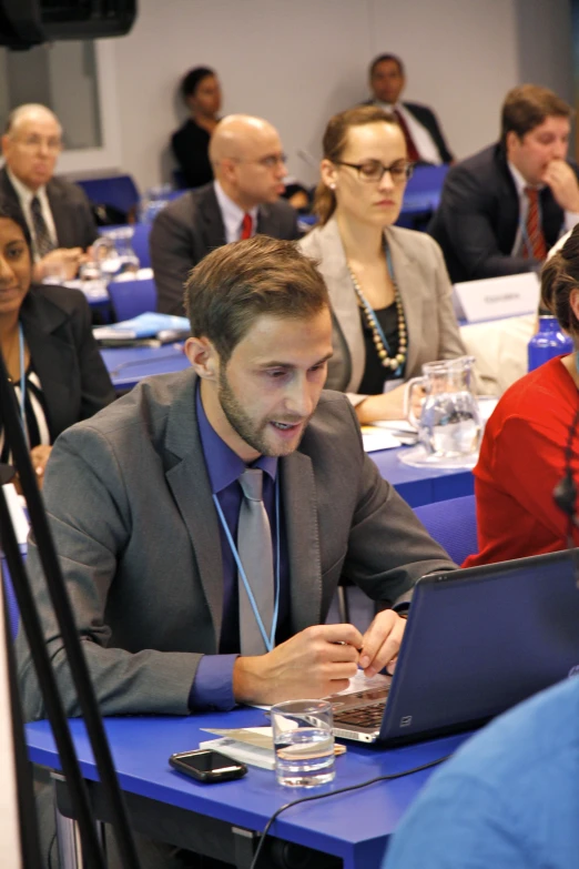 a man sitting at a table with a laptop