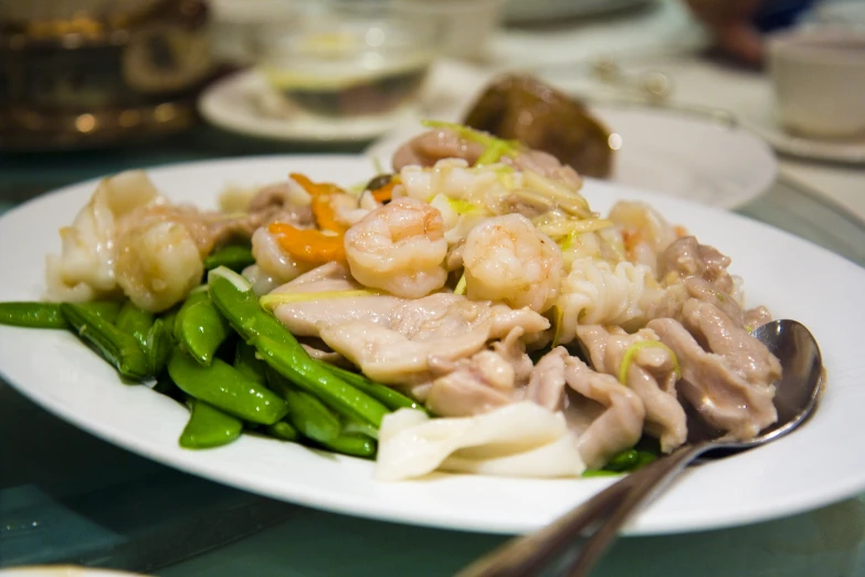 a plate of food that includes shrimp and asparagus