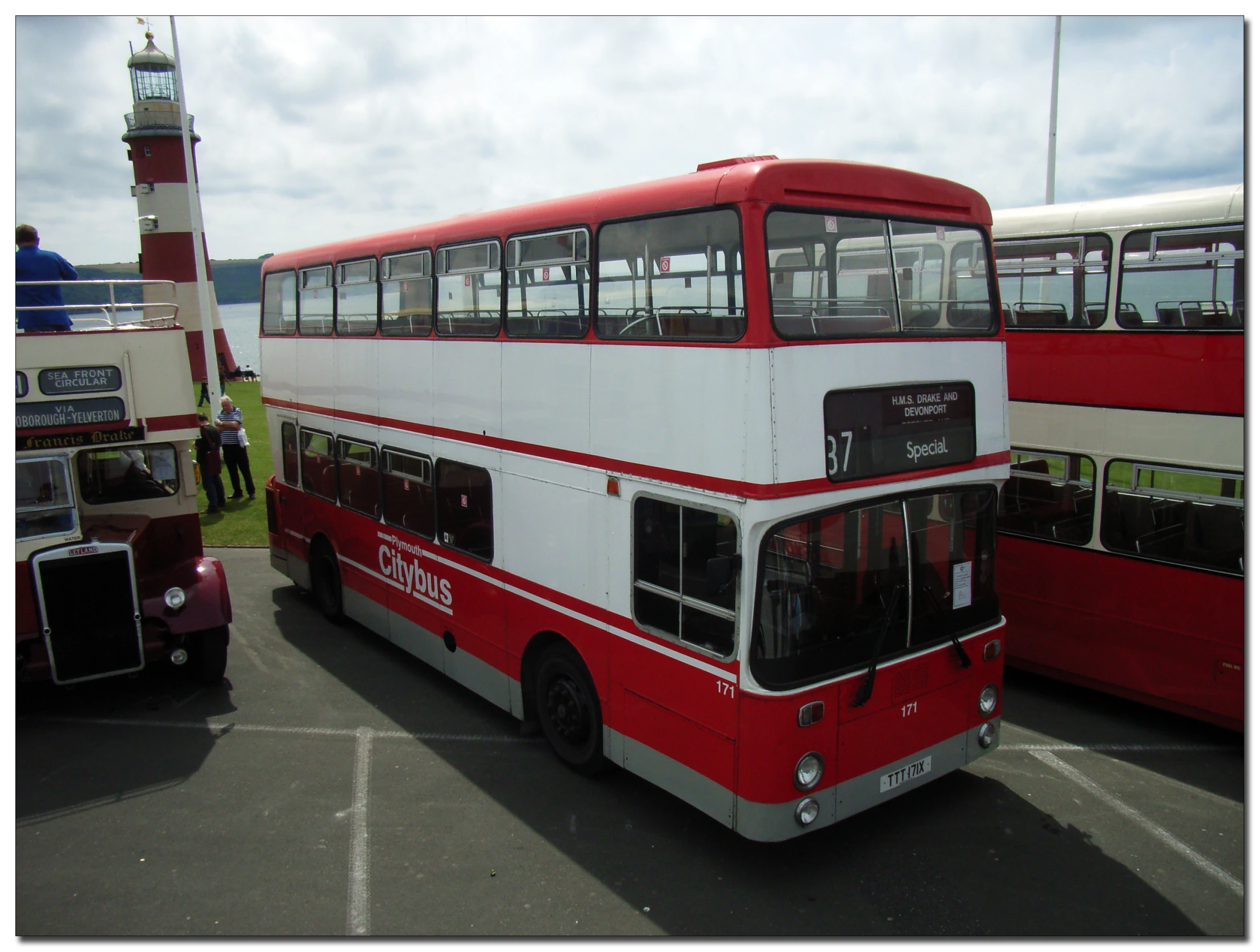 a double deckered bus sitting at the edge of the road