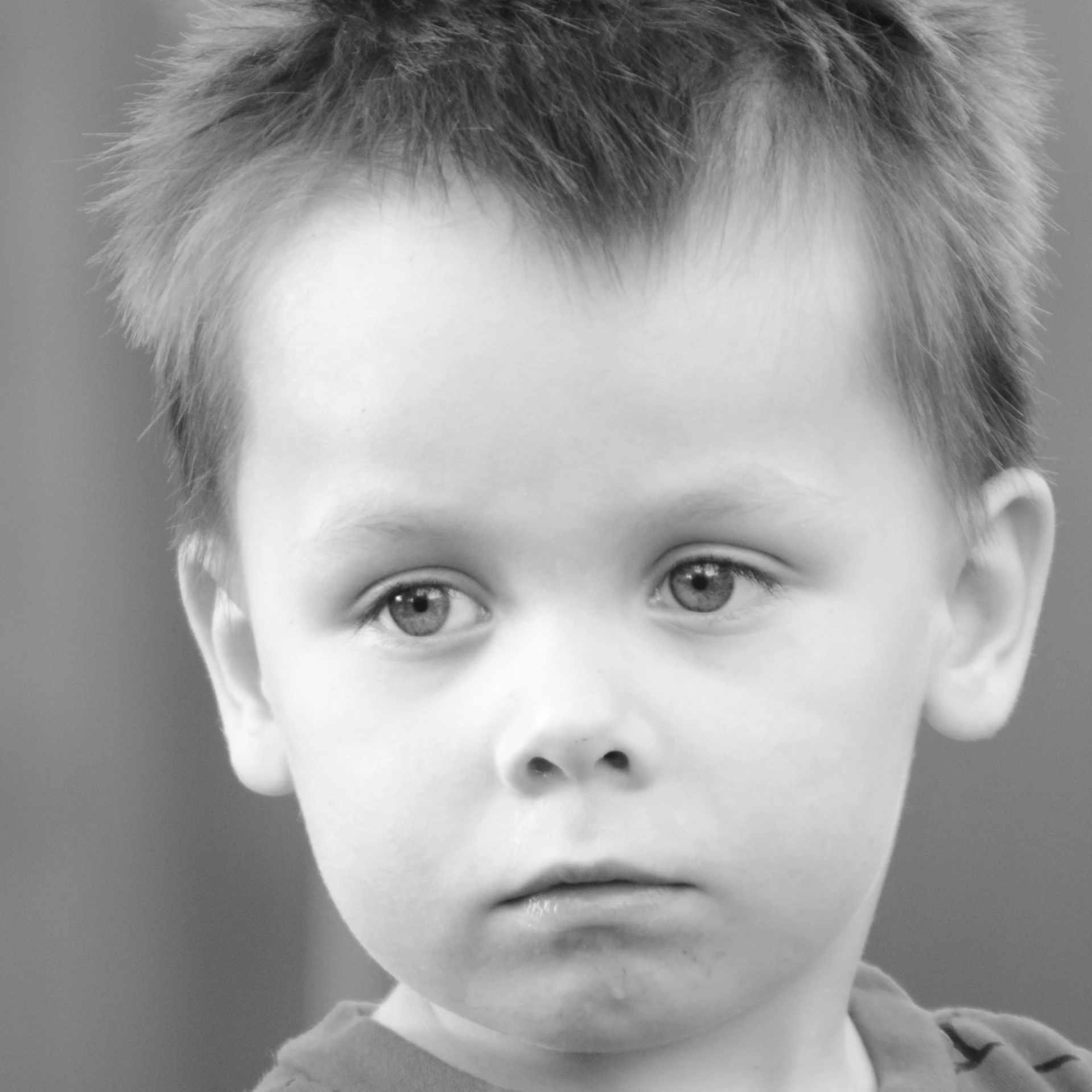 a young child with a messy top on