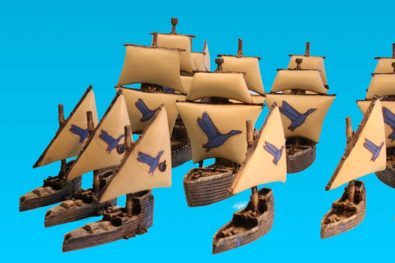 some miniature toy boats set on a blue background
