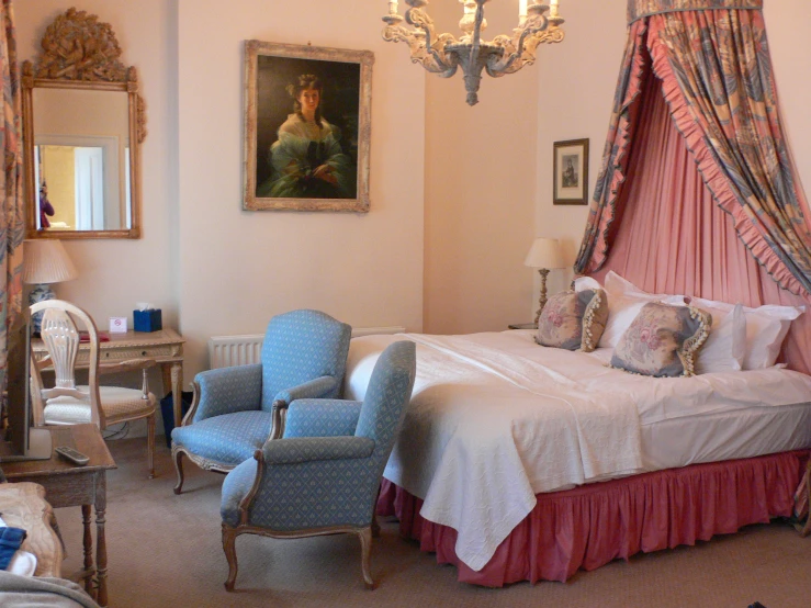 a bedroom is decorated in elegant pink and blue