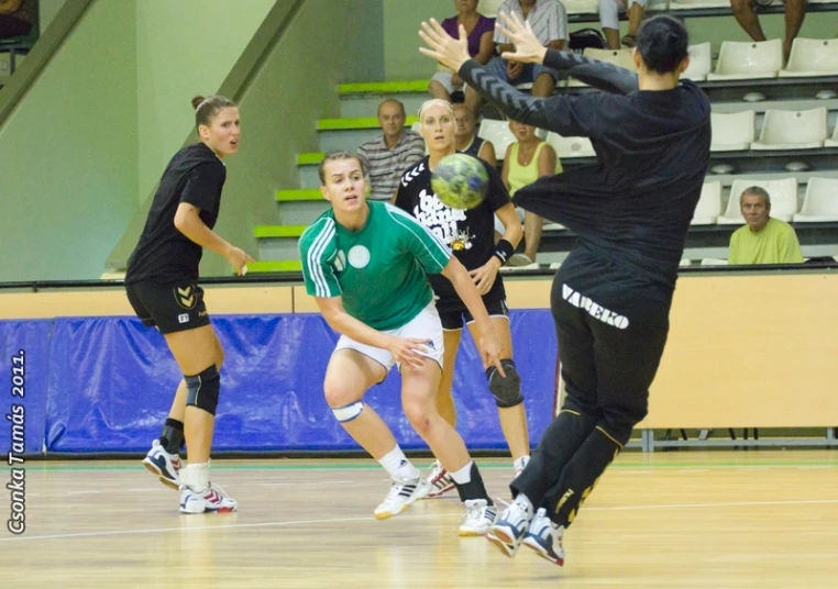 some young women playing basketball on a court