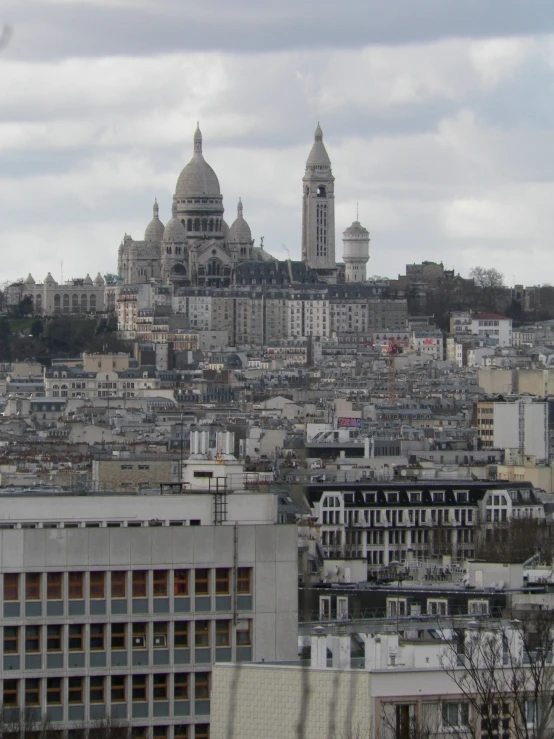 the view of some buildings and a church that is on top