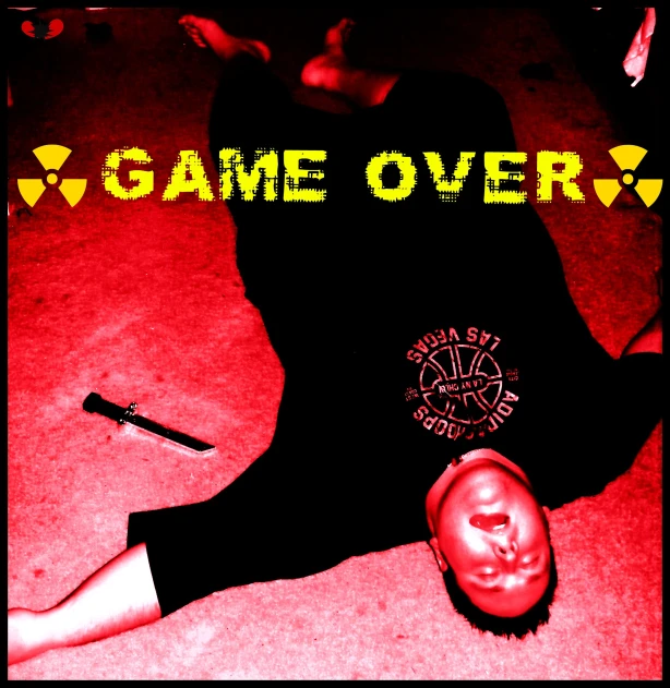a woman laying on the floor next to a game over sign