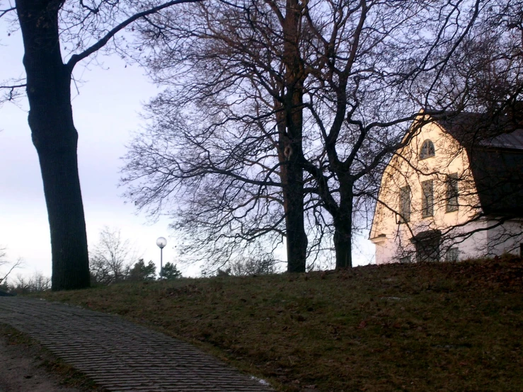 a cobblestone road in front of a stone church