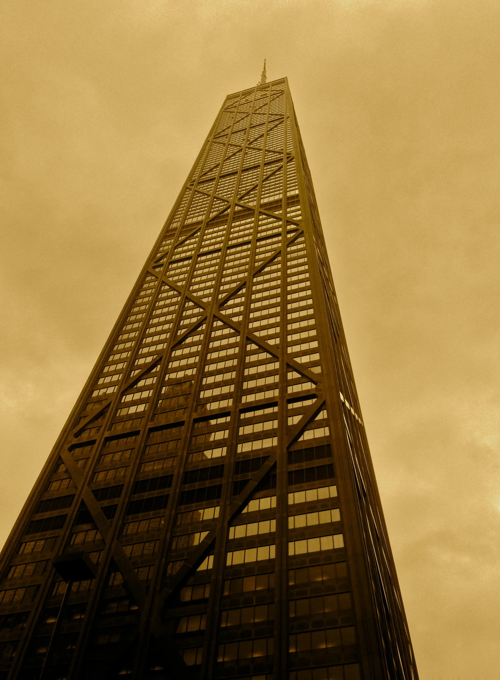 a very tall brown building with some lights on top