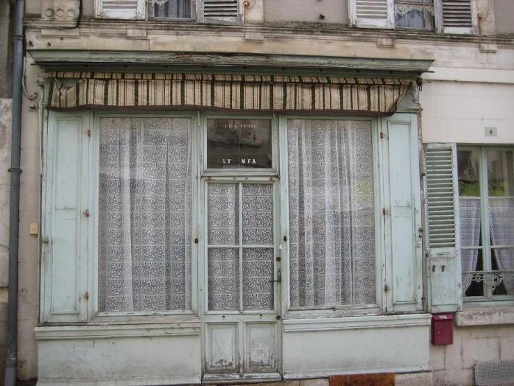 an old run down building with broken windows