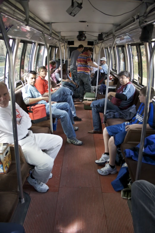 many people sitting in a train on the seats