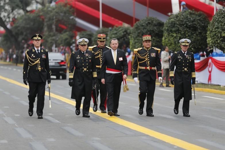 a military marching is being followed on a street