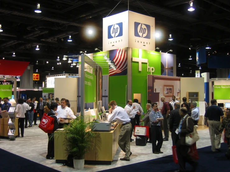 people standing around a stand displaying a display