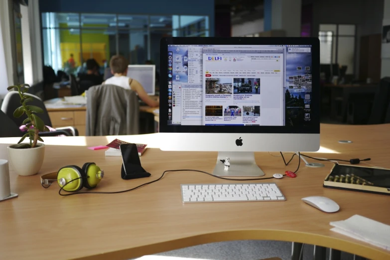 a desk with several computer equipment on it