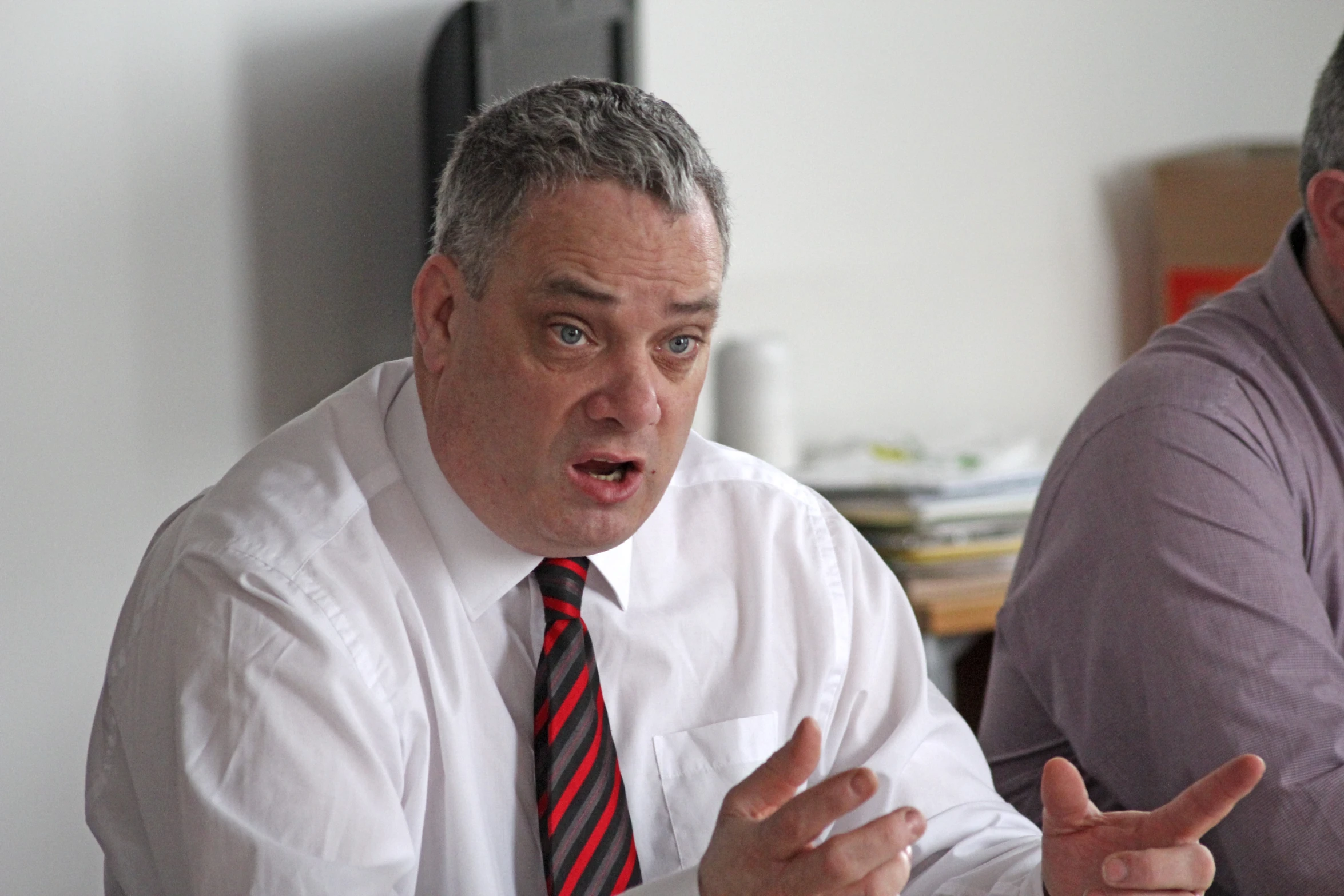 a man with a tie that has his hands open