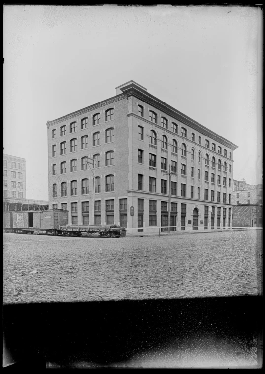 an old brick building with two buildings near by