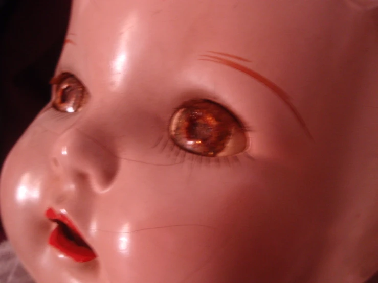 the brown and orange eyes of a doll