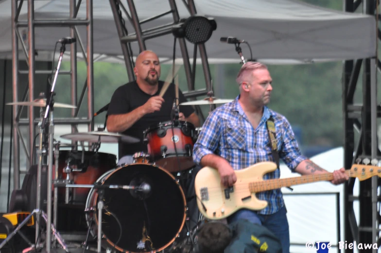 the three musicians are playing with their instruments