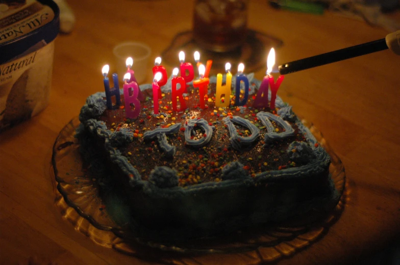 a birthday cake that has some lit candles on it