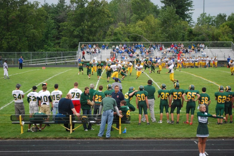 a football game is being played by an adult coach