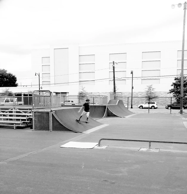 skateboarder riding up a ramp while at the park