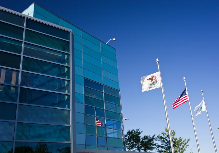 a tall building with lots of windows and a flag