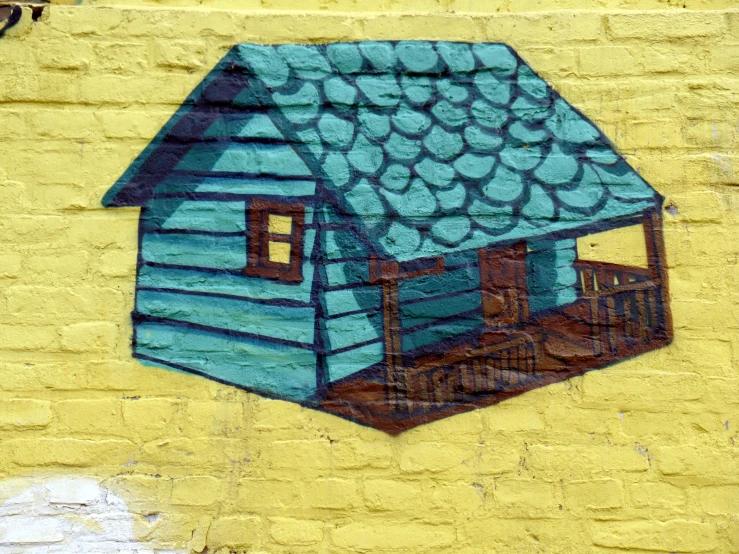 a yellow and blue painted wall with a small blue house on it