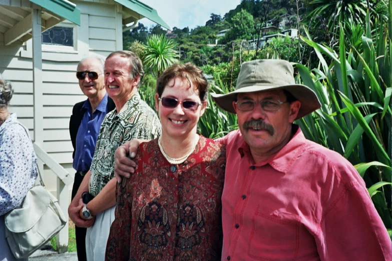 group of people posing for po in front of house