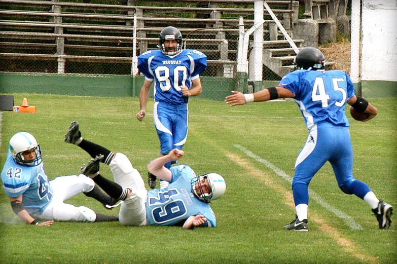 football players in blue uniforms playing on grass