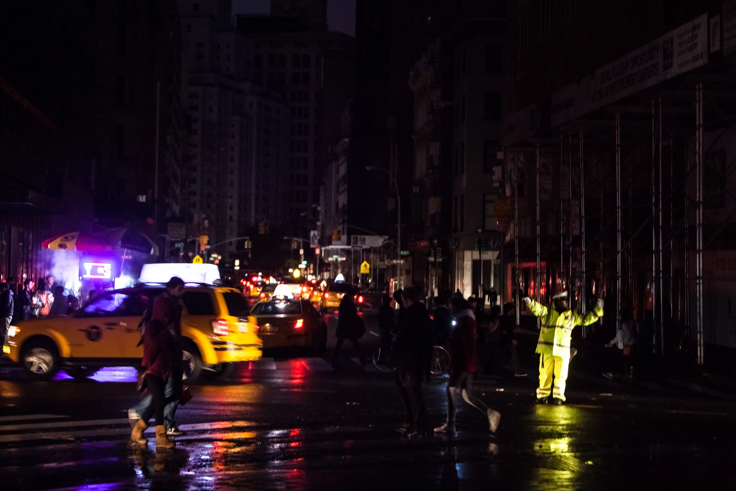 people are standing in the street at night