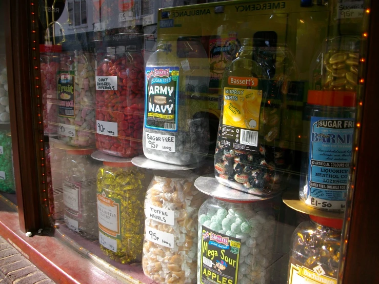 a variety of drinks are seen on display in the window