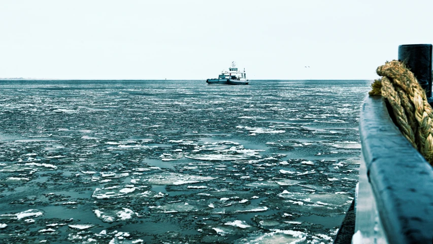 a boat floats through the open ocean