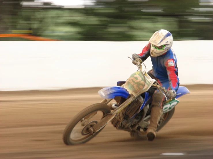 a man is on a dirt bike riding on dirt