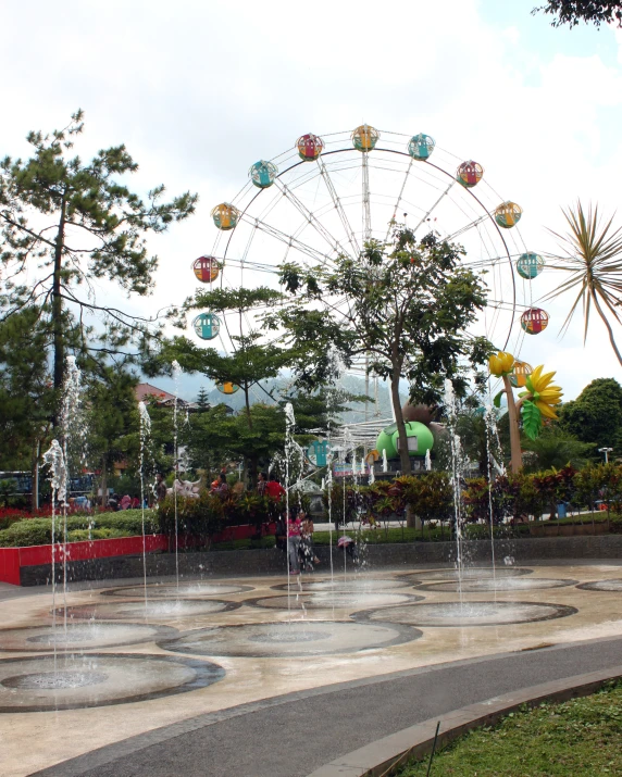 there is a ferris wheel on the side of a street