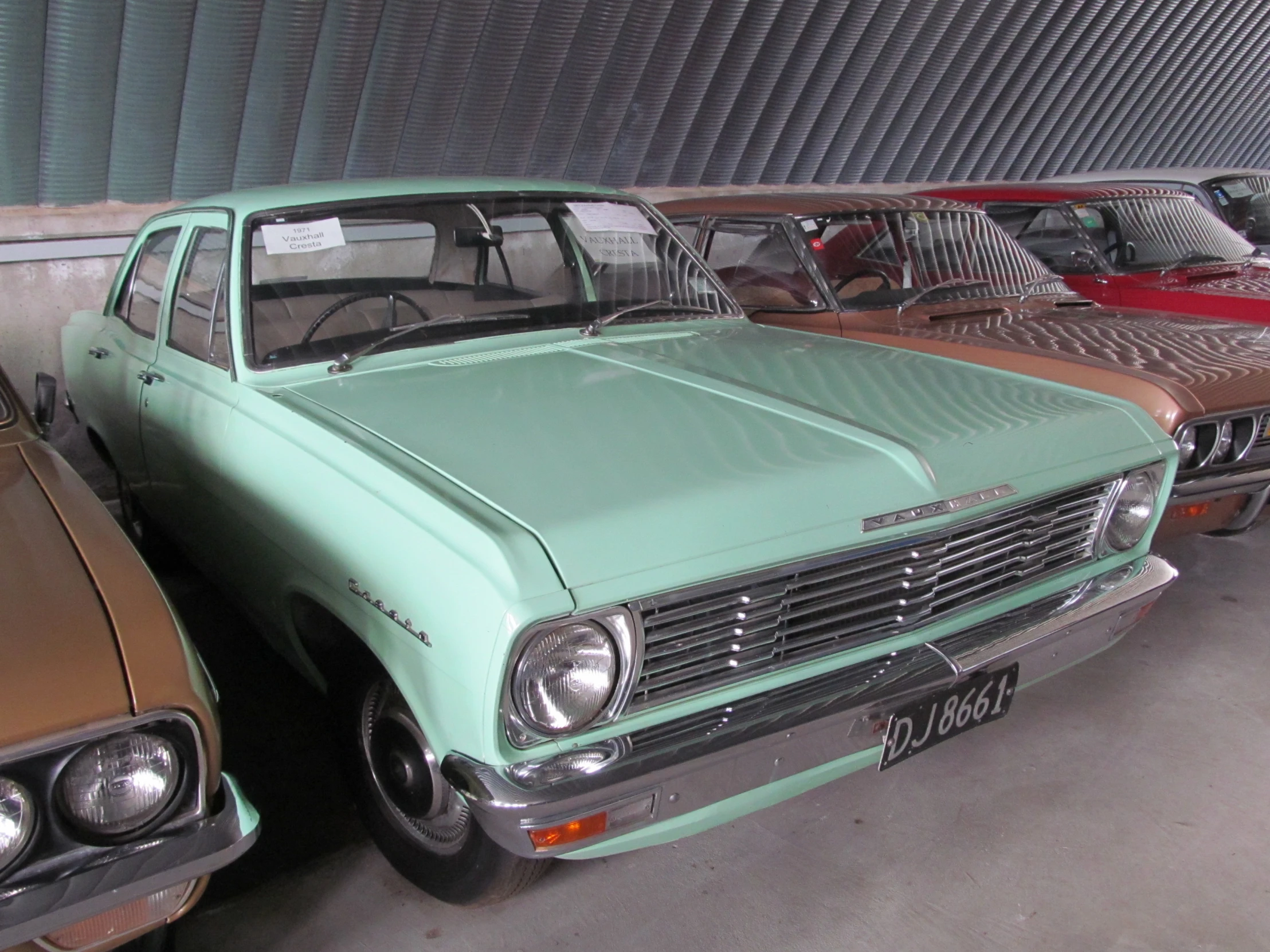 some old cars are standing next to each other