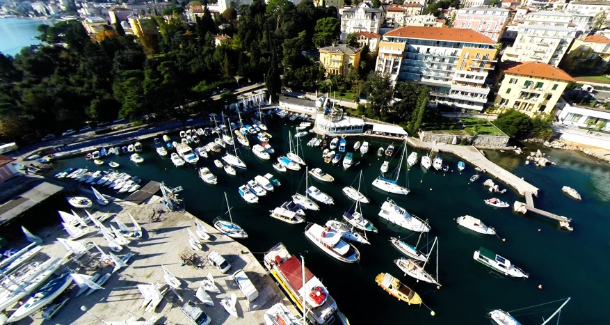 many boats are docked at a bay by the buildings