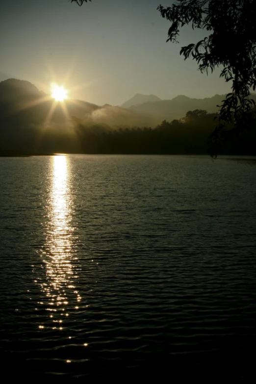 sun is shining through the clouds over the water