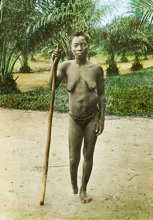 a black and white po of a  boy holding a stick