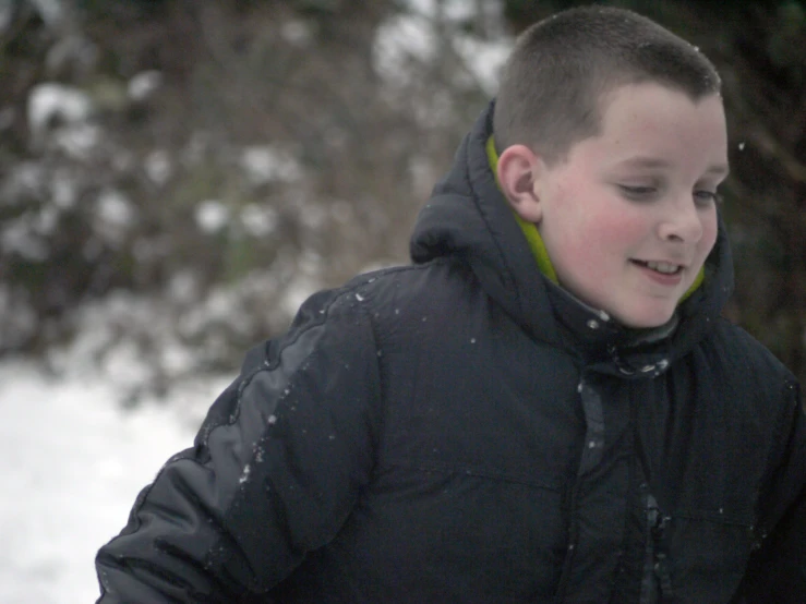 a  in the snow wearing a black jacket