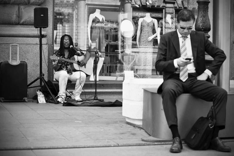 a man sitting on a bench in front of a store