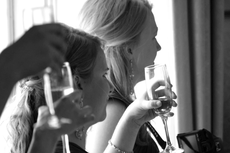 two girls enjoying their drinks at a table