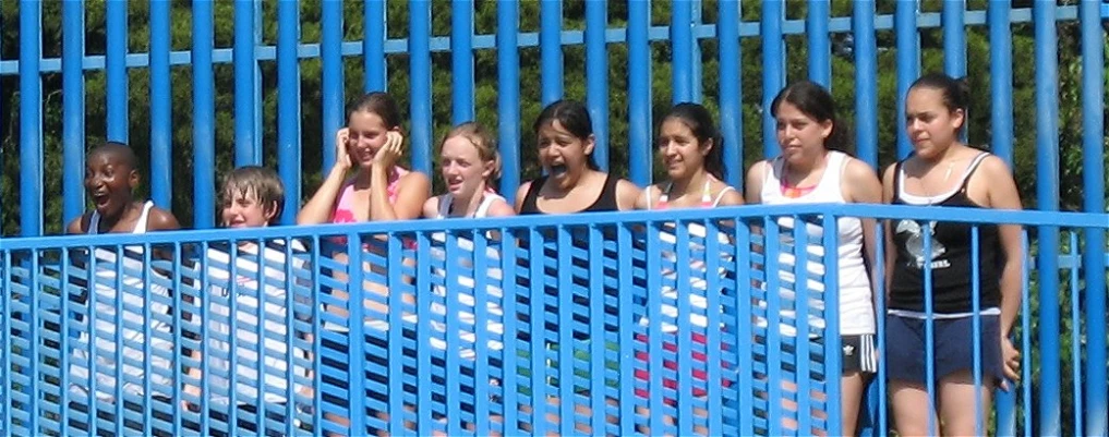 a group of s standing next to each other on a swimming raft