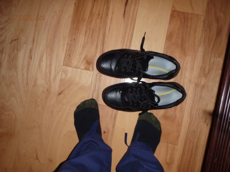 a pair of shoes is shown on the floor next to a pair of pants