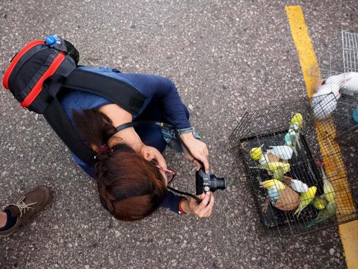 a person holding an object and sitting in the street