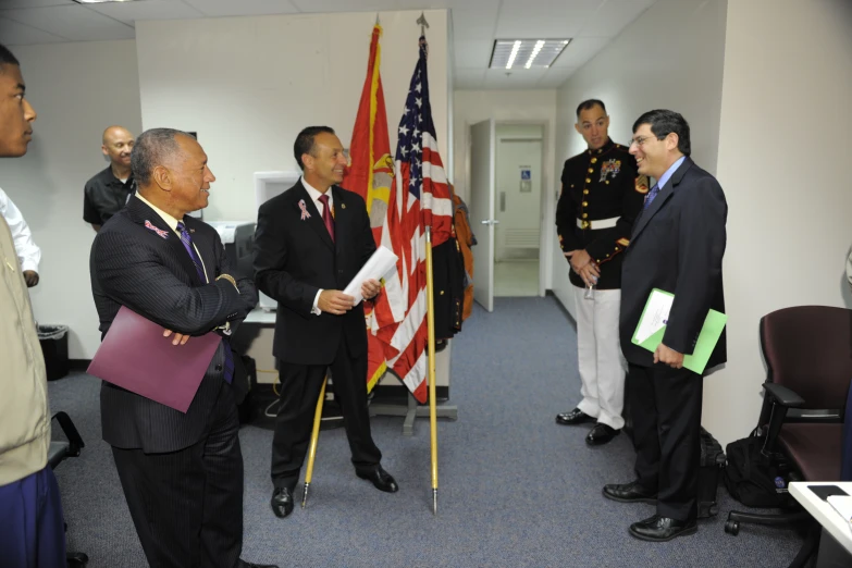 military officials meeting in a public hallway