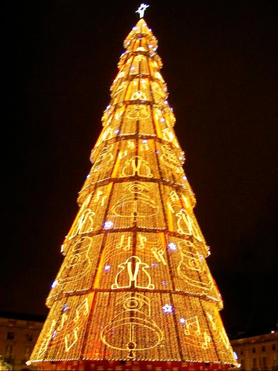 a lit up christmas tree at night with lights