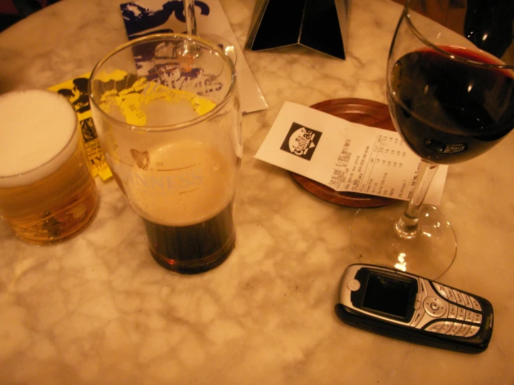 the glass with the cell phone on the table next to it is empty