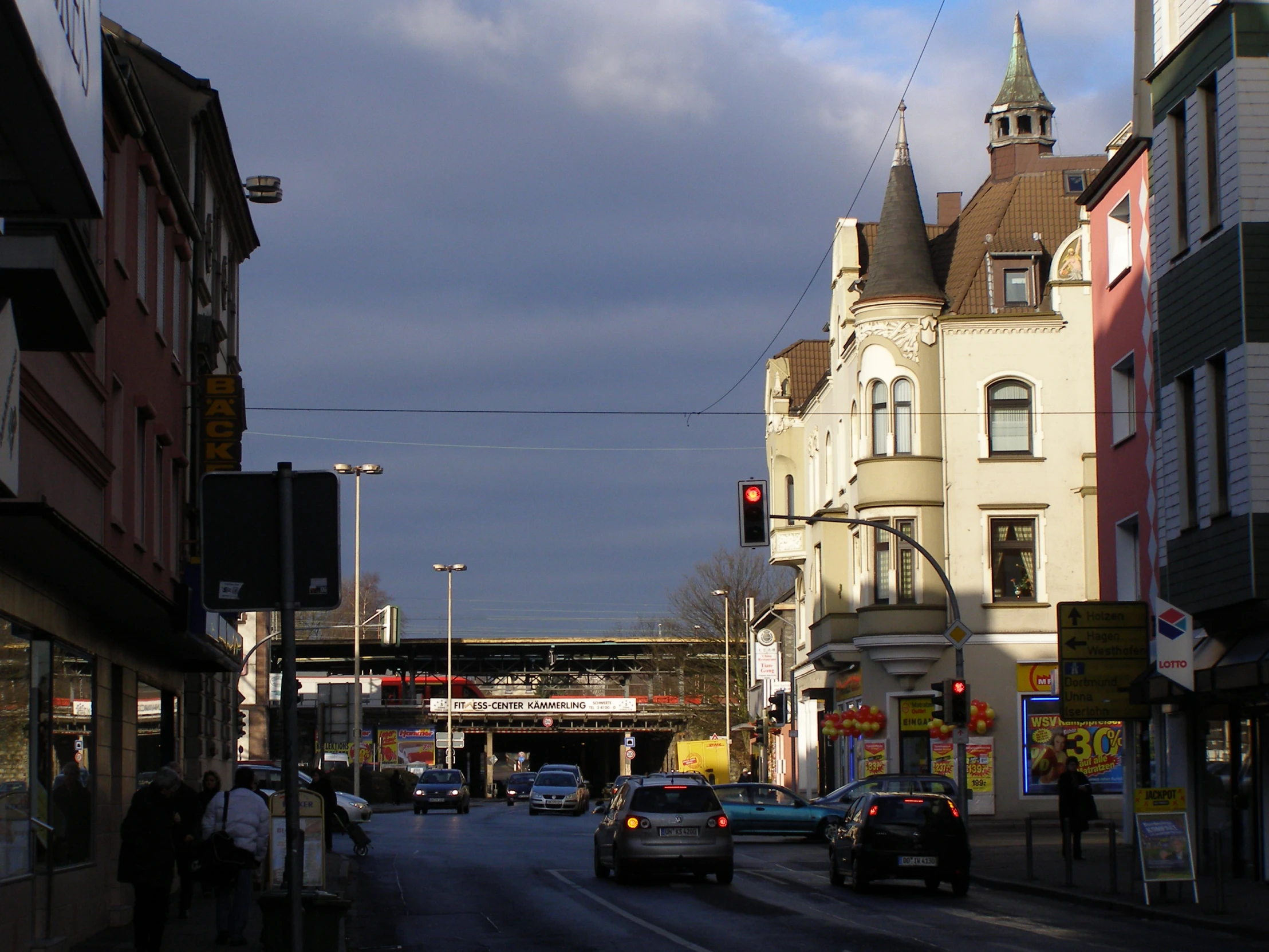 a couple of cars that are driving by buildings