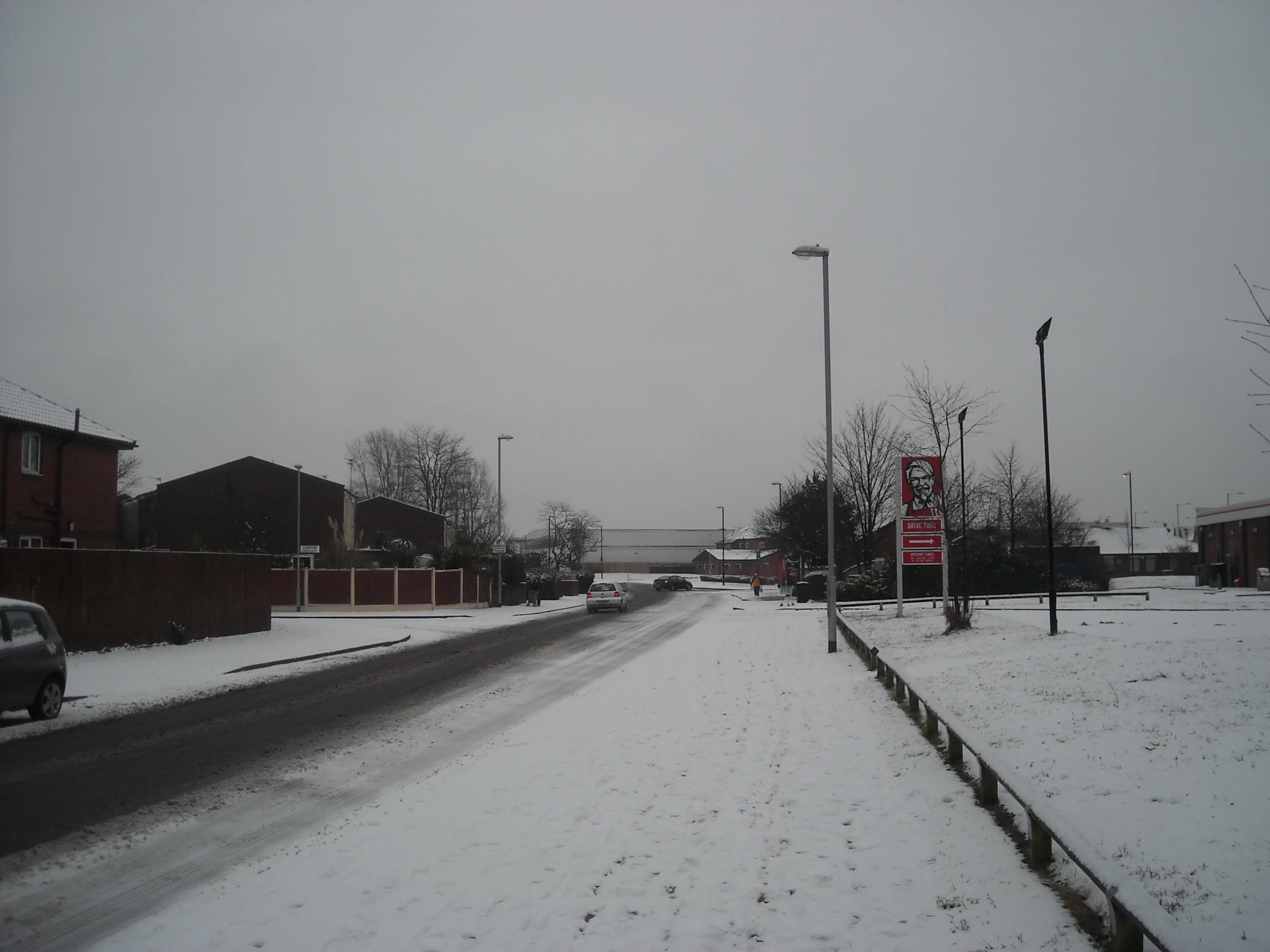 a street with snow and power poles