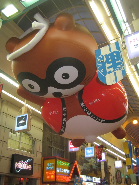 a shopping mall with an inflatable animal balloon